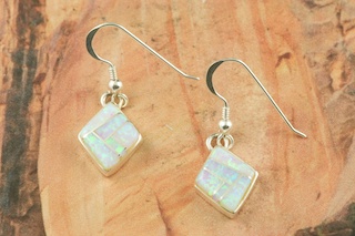 Stunning Fire and Ice Lab Opals inlaid between ribbons of Sterling Silver. Beautiful Sterling Silver French Wire Earrings feature precision channel inlay. Designed by Navajo Artist Calvin Begay. Signed.